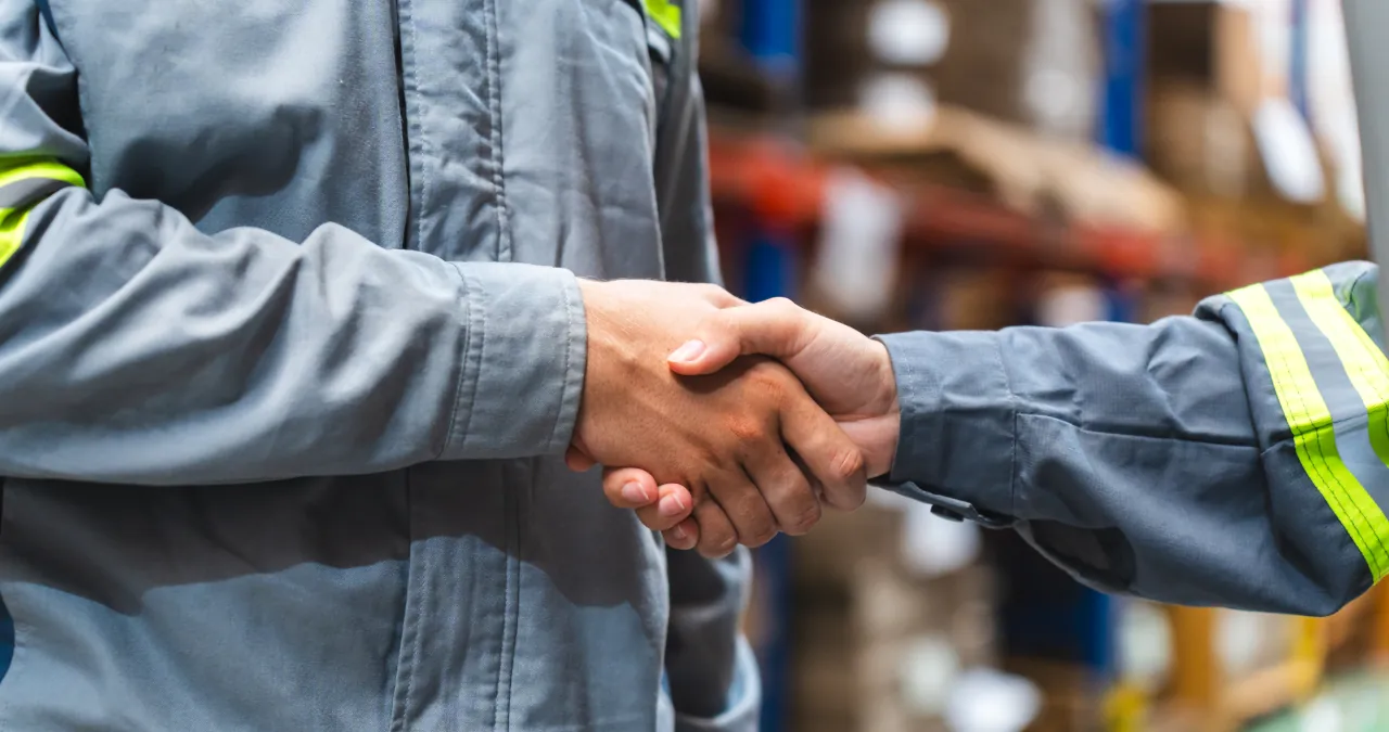 A closeup of a handshake in an industrial setting